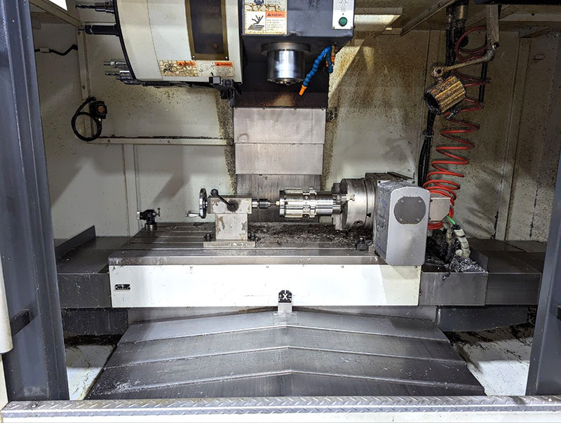 Spindle, work table and index unit of CNC machine before cleaning