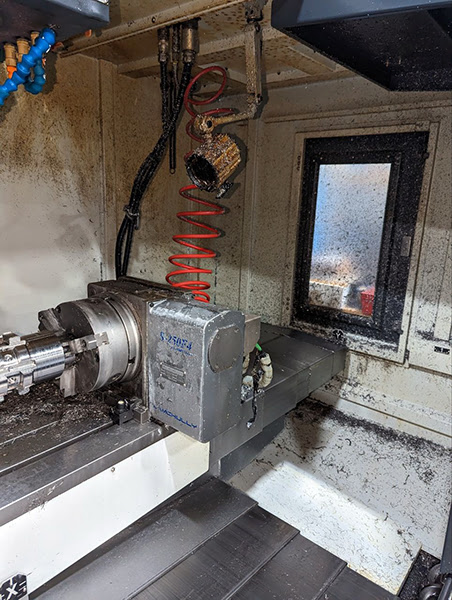 Work area and index unit of CNC machine before cleaning